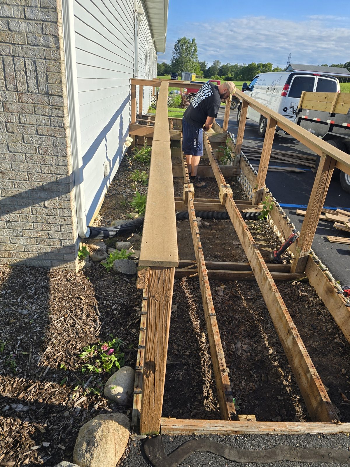 Old wooden accessible ramp being torn out along a building in Southwest Michigan