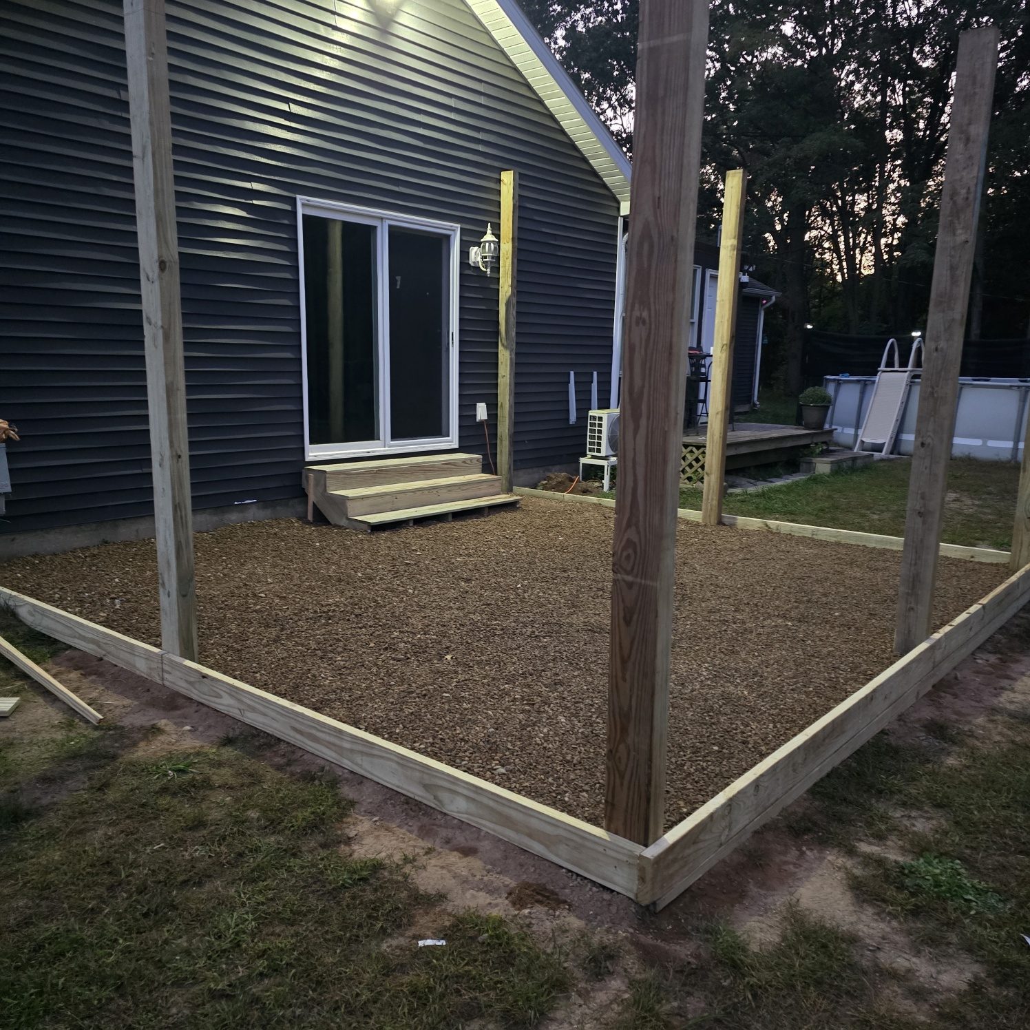 Timber framed gravel base and fence posts set for a backyard hot tub area in Southwest Michigan