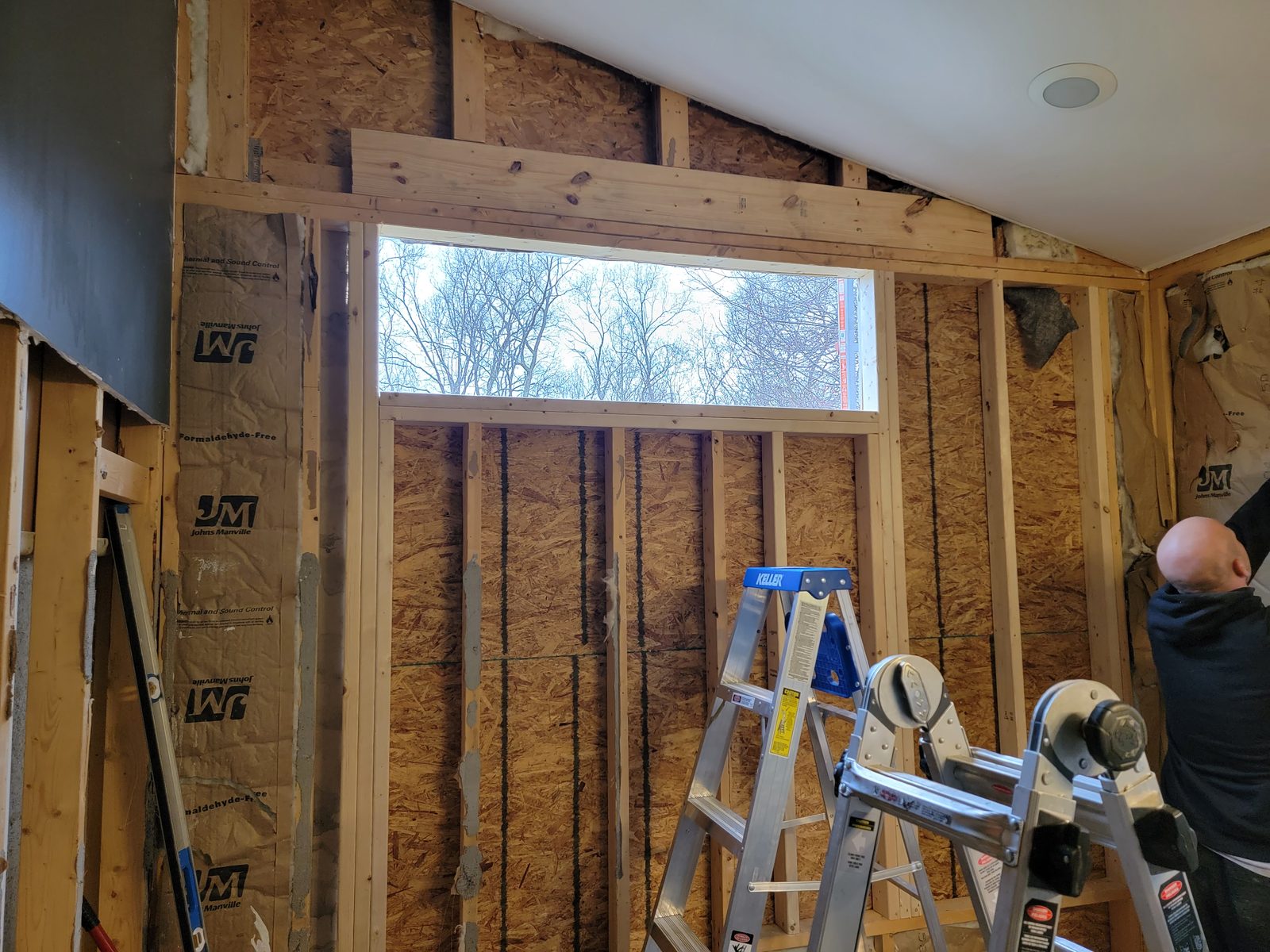 Bathroom wall reframed for a high transom window during a remodel in Southwest Michigan