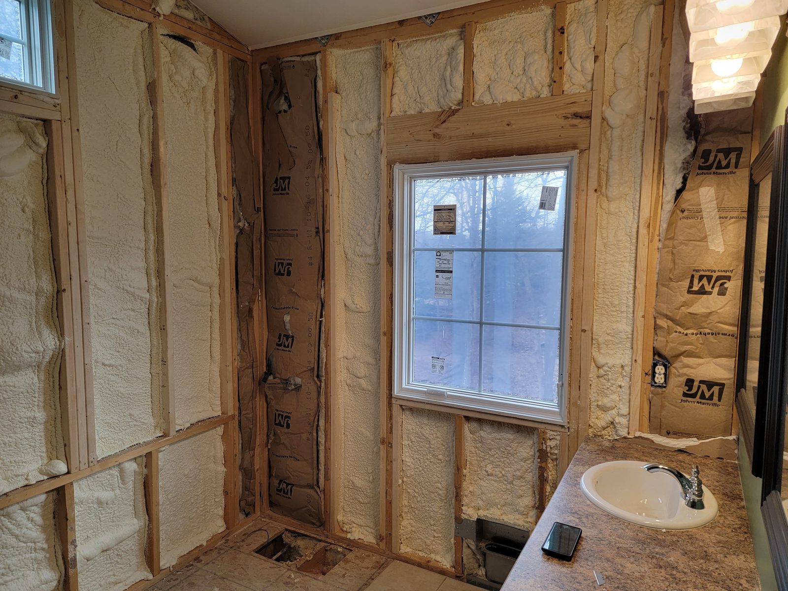 New window over the vanity with spray foam insulated walls during a bathroom remodel in Southwest Michigan