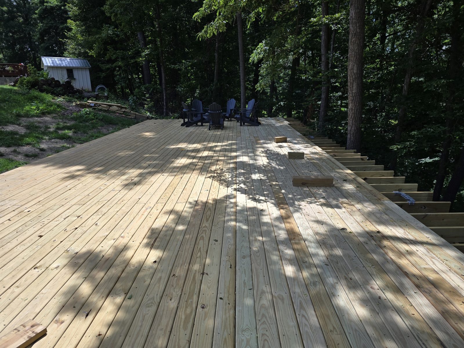 New pressure treated decking on a large ground level deck in Southwest Michigan