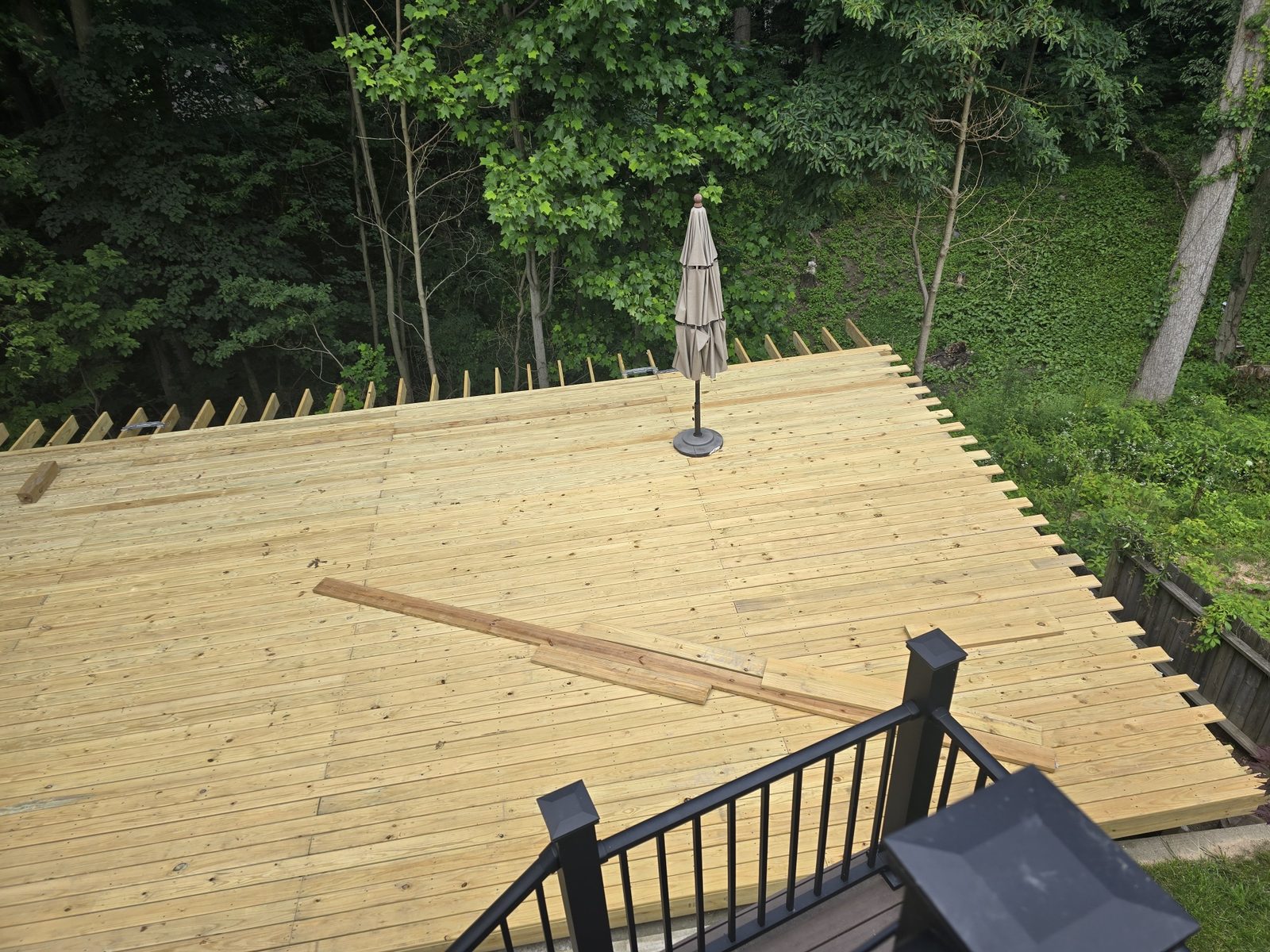 View from the upper deck stairs of a large new ground level deck in Southwest Michigan