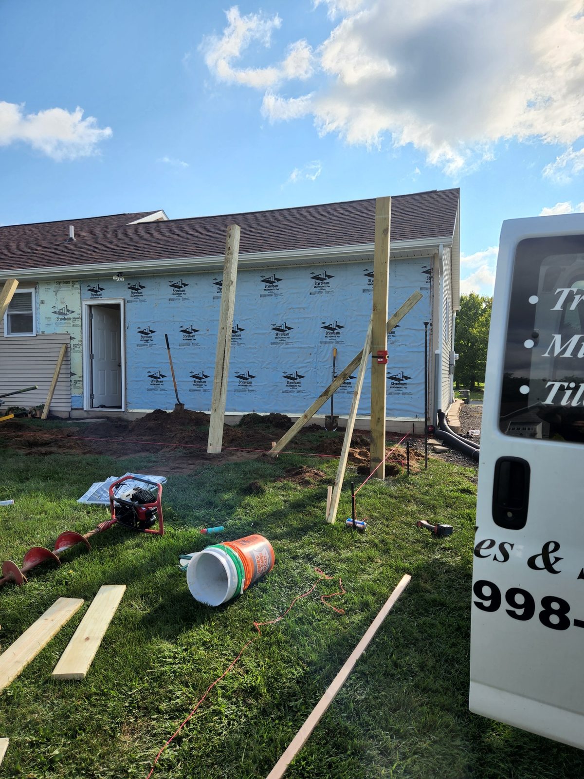 Posts braced over new footings for an attached garage in Southwest Michigan