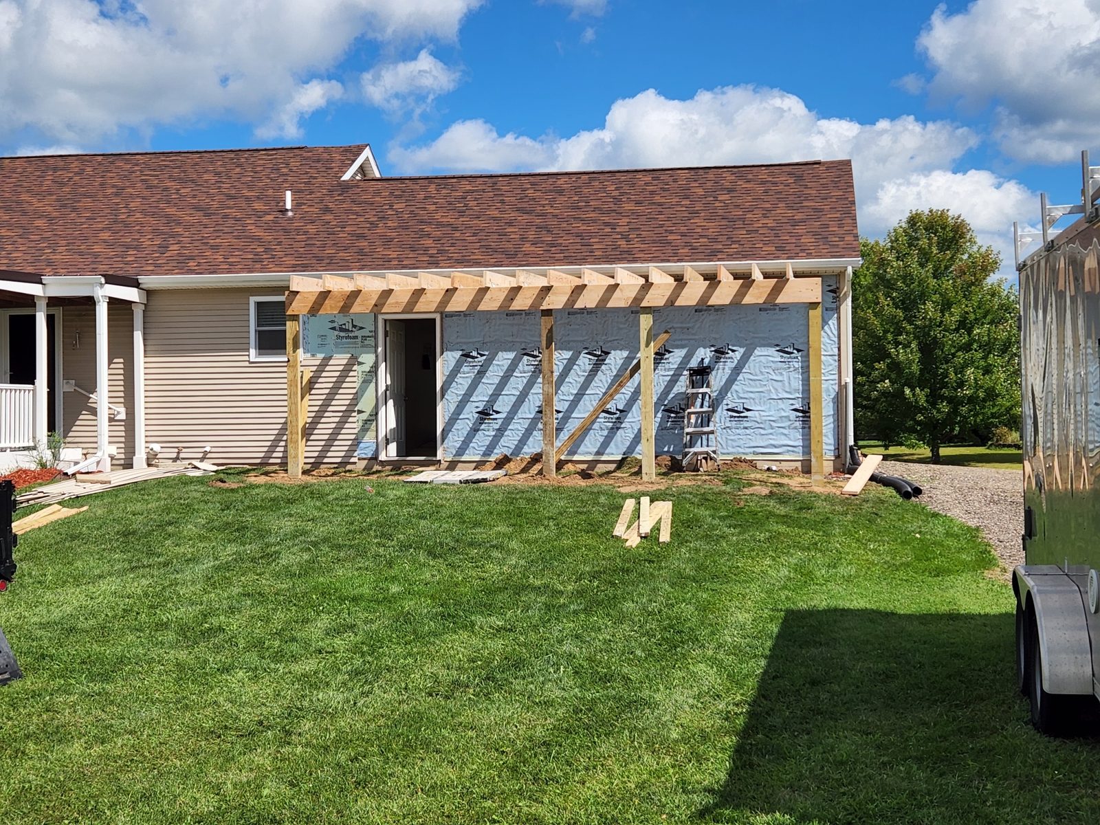 Framing for a new garage addition along the side of a house in Southwest Michigan