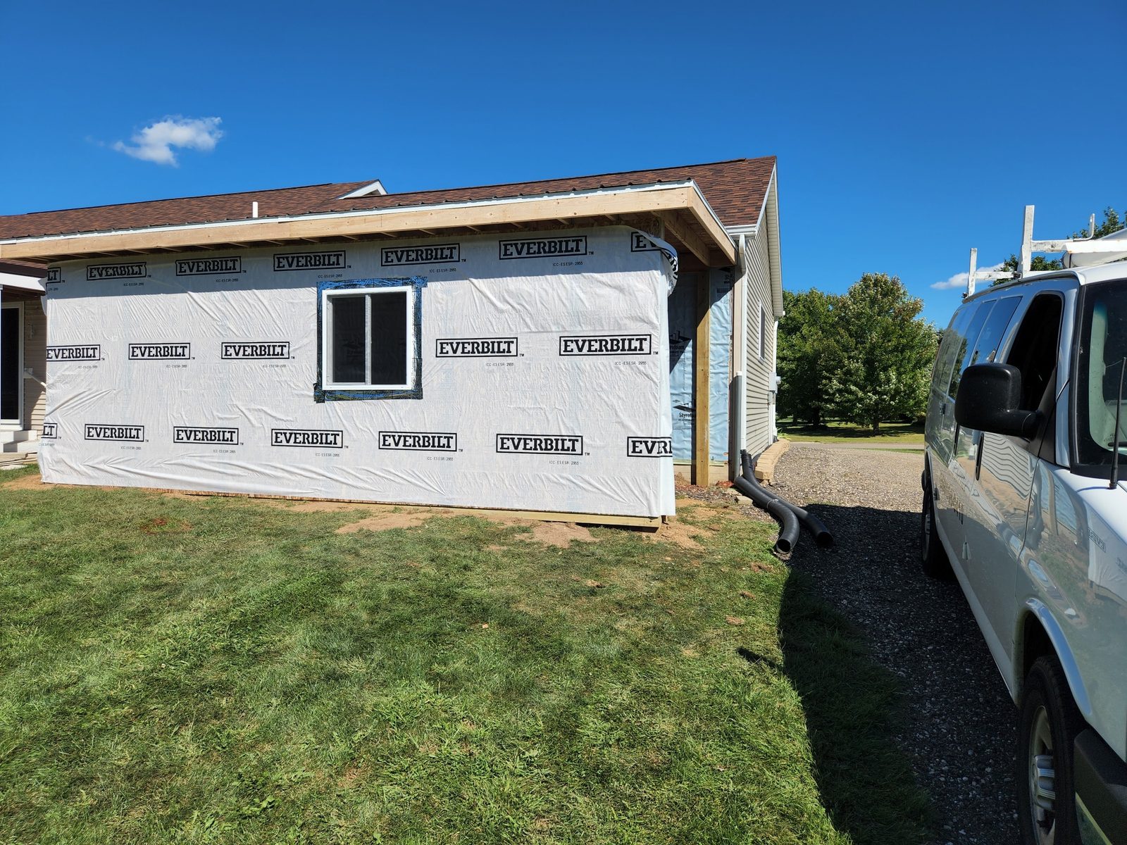 New garage walls sheathed and wrapped with a window in place in Southwest Michigan