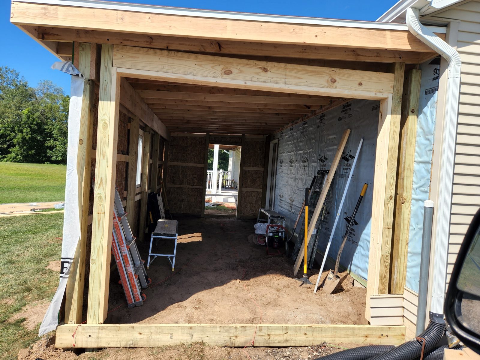 Inside the framed shell of a new attached garage in Southwest Michigan