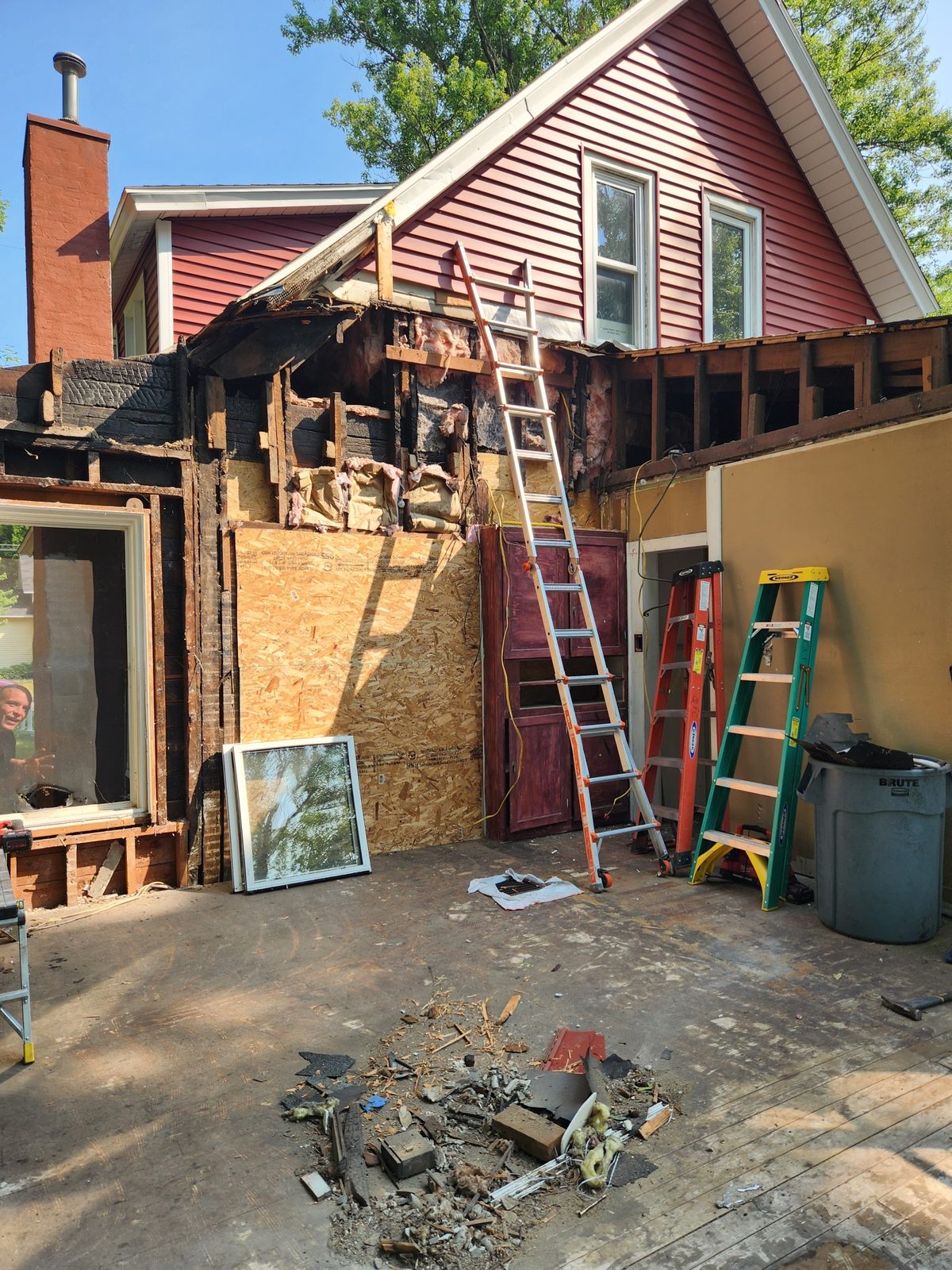 Old rear addition of a red house stripped down to the framing during a remodel in Southwest Michigan