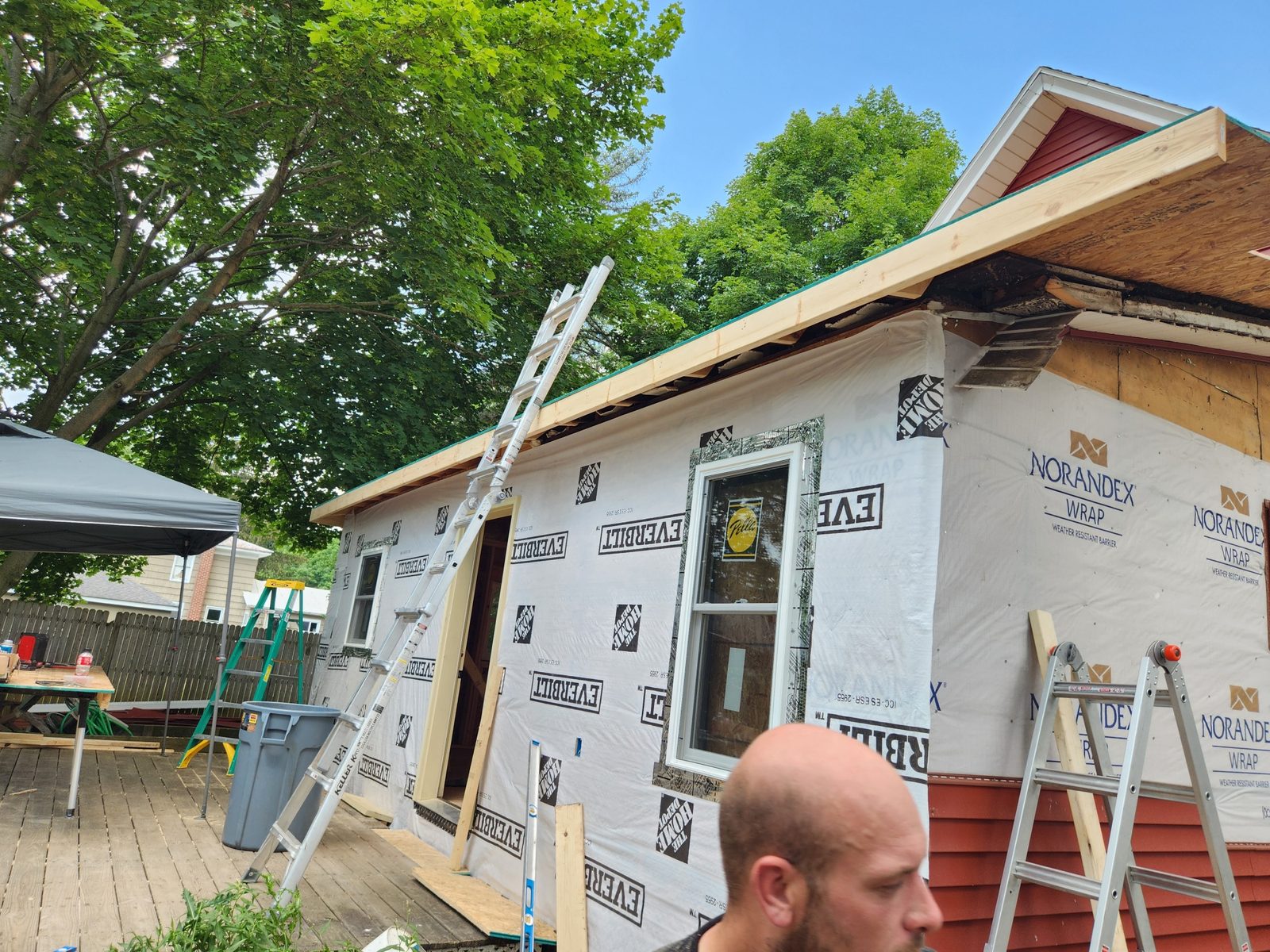 Rebuilt rear addition wrapped and trimmed out, ready for siding, in Southwest Michigan
