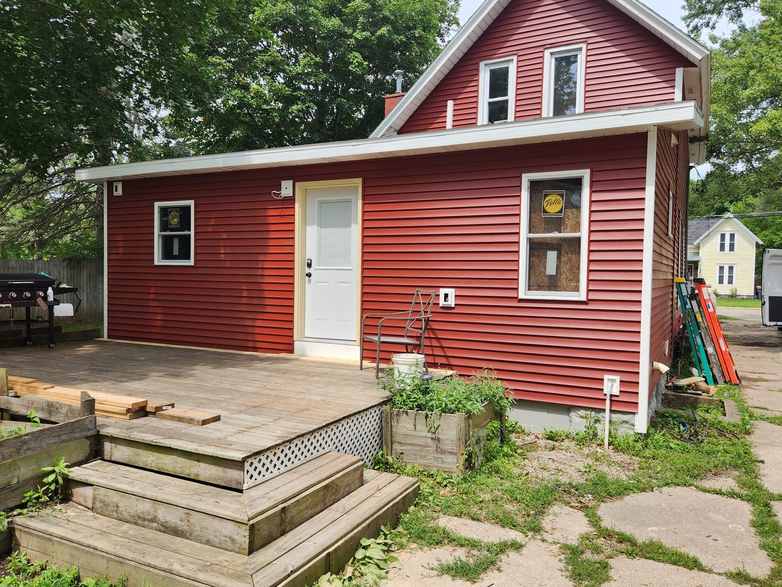 Finished rear addition with red lap siding, white trim and a new entry door in Southwest Michigan