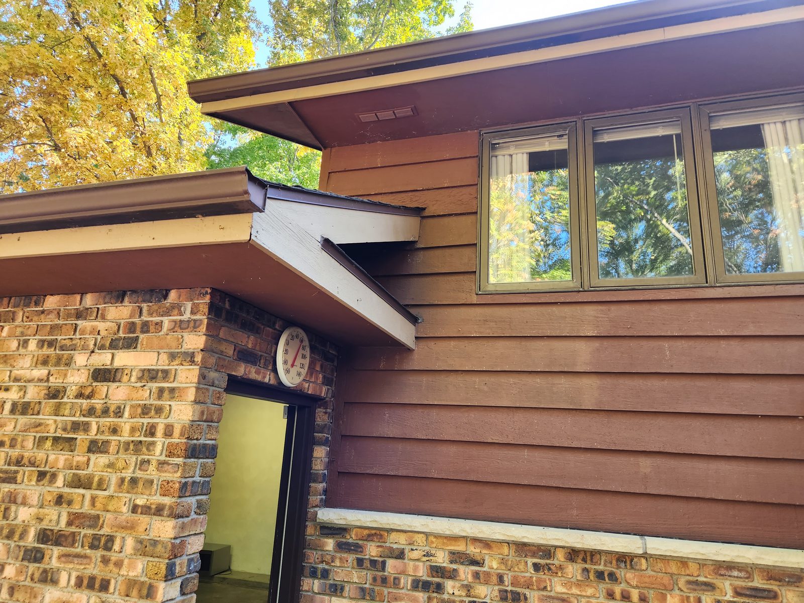 Roof edge and fascia above a side entry before repair on a home in Southwest Michigan
