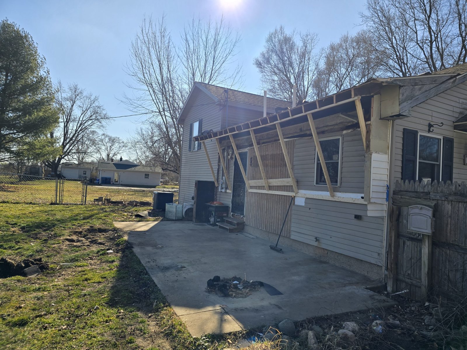 The back of a house in Southwest Michigan before a room addition, with an old covered porch along the rear wall