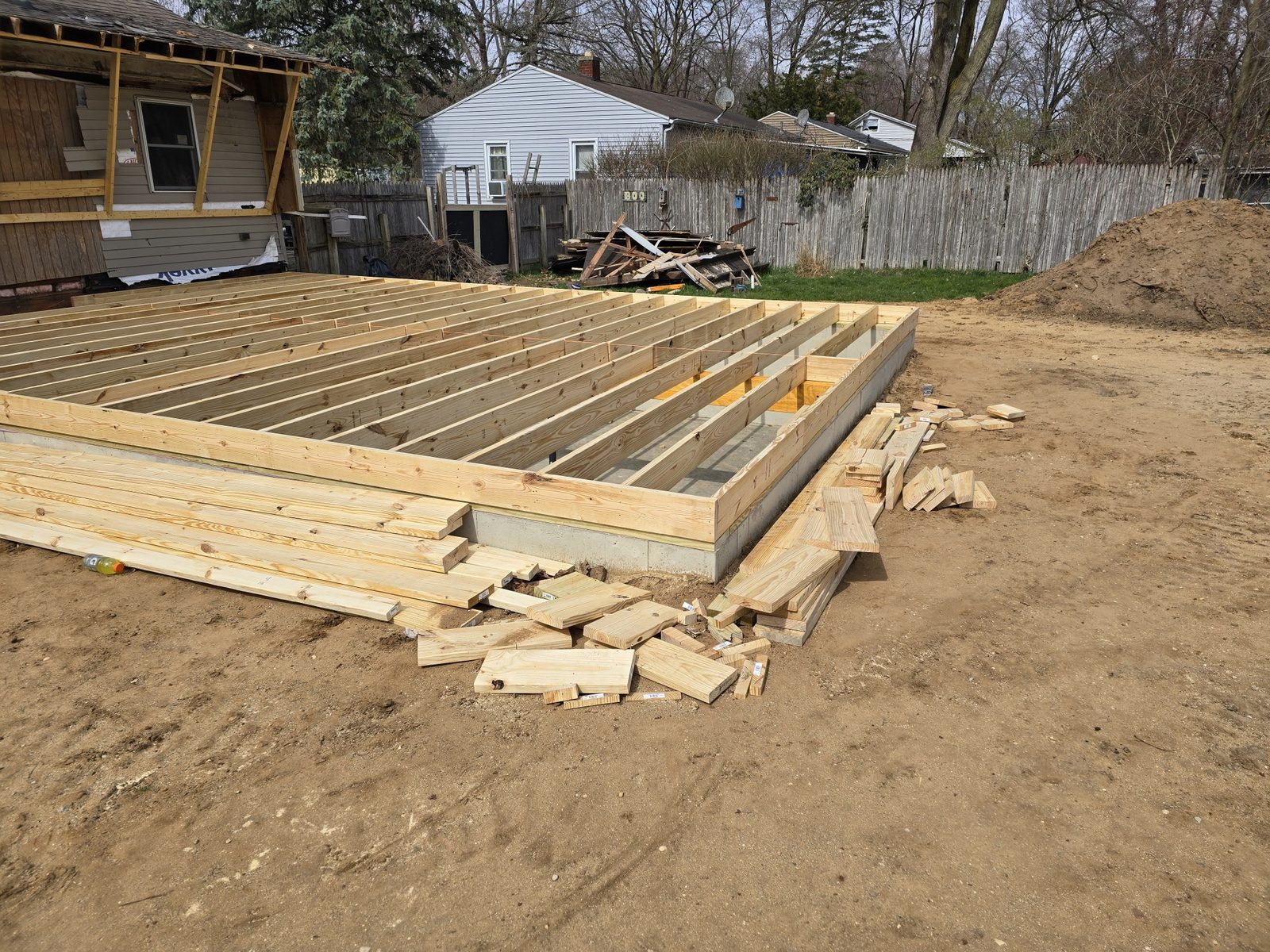 New floor joists framed on the foundation of a room addition in Southwest Michigan