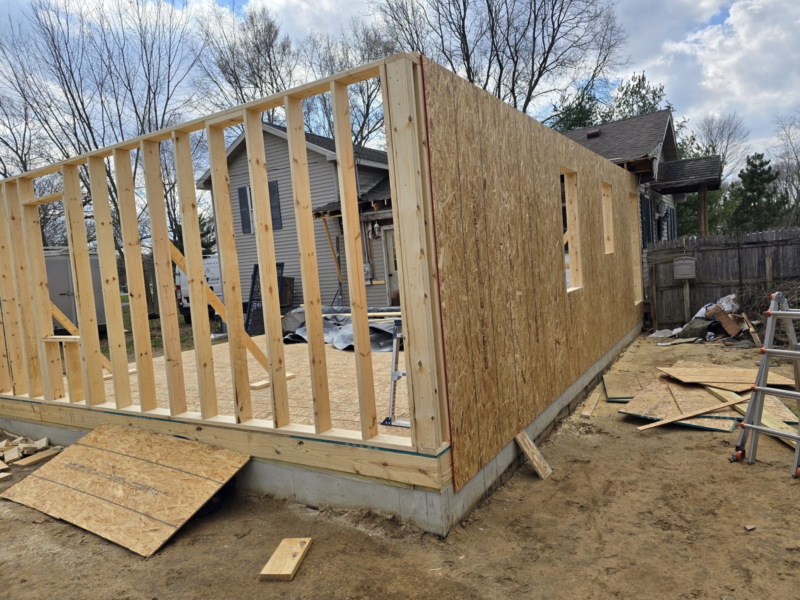 Wall framing and sheathing going up on a new room addition in Southwest Michigan